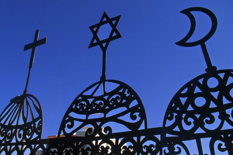 Photo of three religious symbols - a Cross, Jewish Star, and crescent moon.