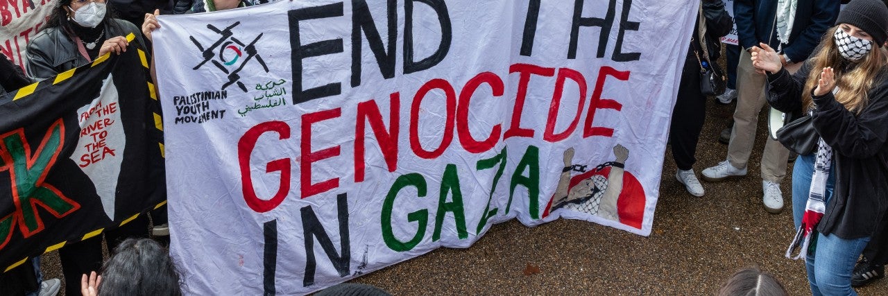 Protest with the sign that says "End the Genocide in Gaza"