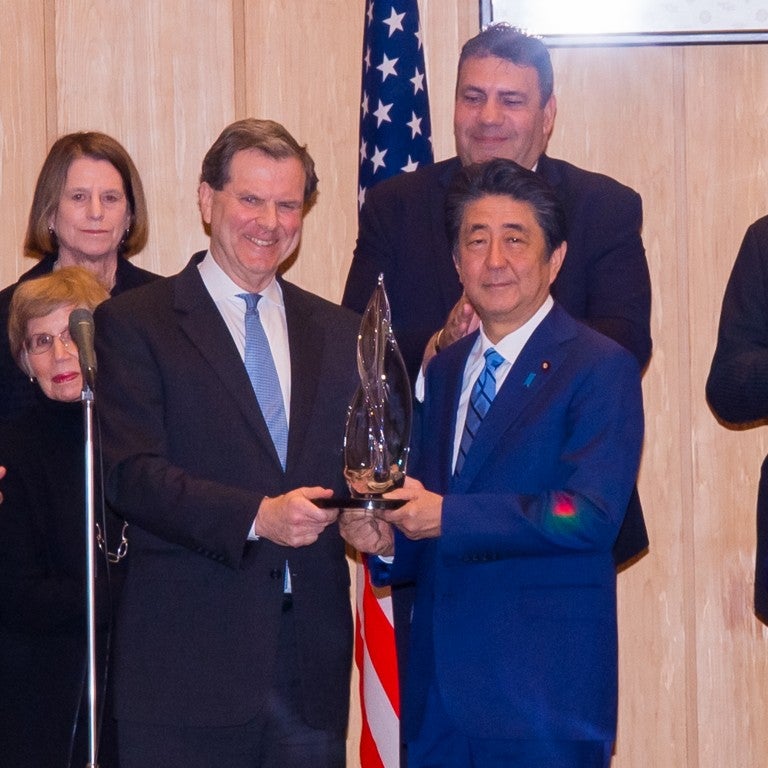 Photo of AJC CEO David Harris presenting AJC Light Unto Nations Award to Japanese Prime Minister Abe Shinzo
