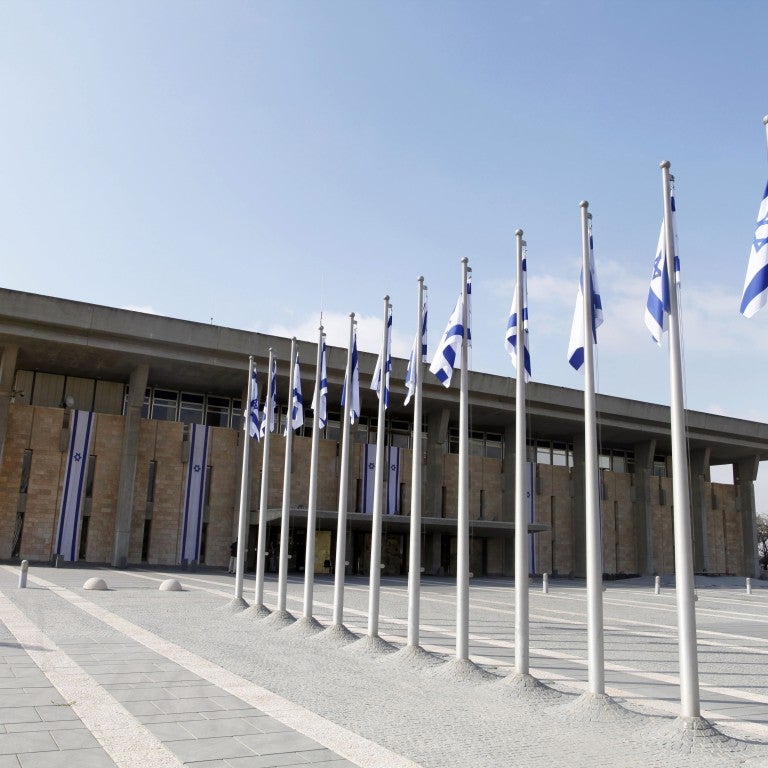 photo of flags outside Knesset building , Israeli parliament.