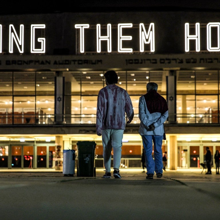 TOPSHOT - A neon sign reading "BRING THEM HOME", referring to the Israeli hostages held in Gaza since the October 7 attacks, is displayed atop the Charles Bronfman Auditorium (Heichal HaTarbut) at HaBima Square in Tel Aviv on December 9, 2023. Israeli forces have encircled major urban centres in the Gaza Strip as they seek to destroy Hamas over its unprecedented attack in October when militants broke through Gaza's militarised border to kill around 1,200 people and seize hostages, 138 of whom remain captive