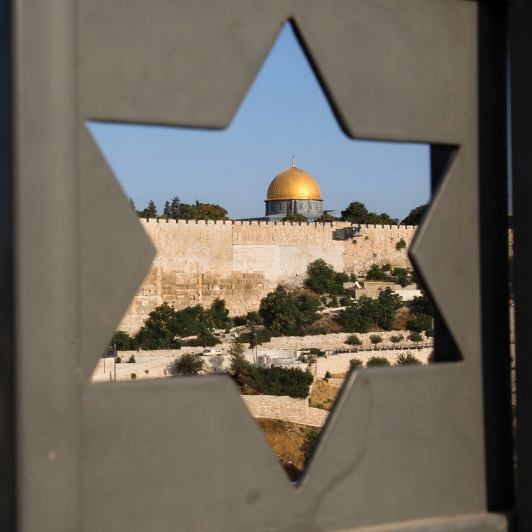 Photo of the Dome of the Rock as seen through a Star of David shaped window