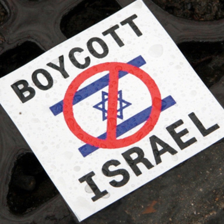 Photo of a sign saying "Boycott Israel" with a crossed-out Israeli flag
